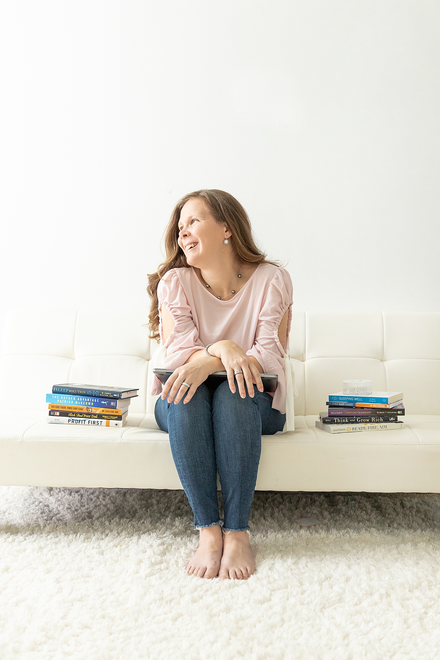 Woman sitting on a bench with books beside her | Image by Chrissy Winchester Photography