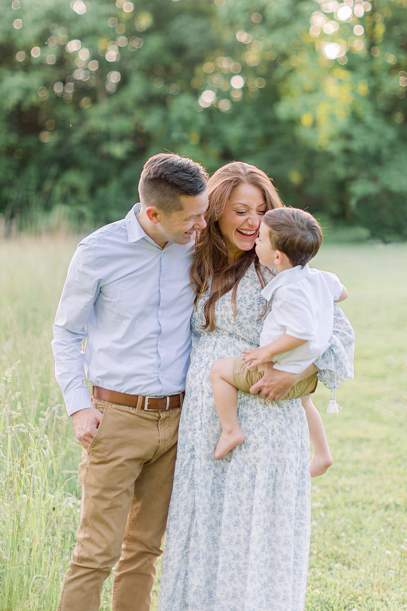 Mom and dad holding their little boy | Image by Chrissy Winchester