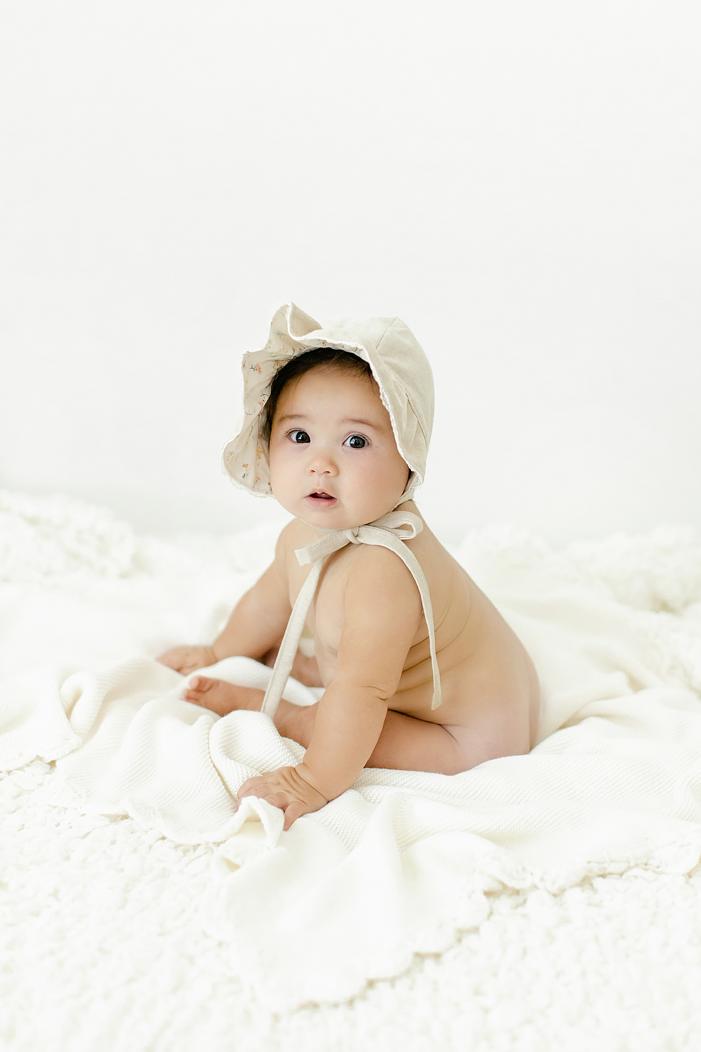 Baby girl in a bonnet | Image by Chrissy Winchester Photography