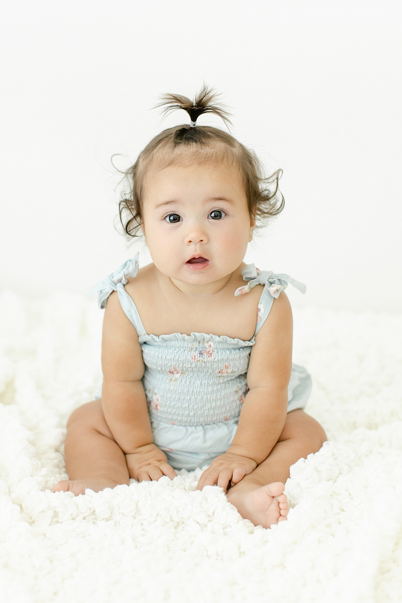 Detail of baby girl in a blue jumper | Image by Chrissy Winchester Photography