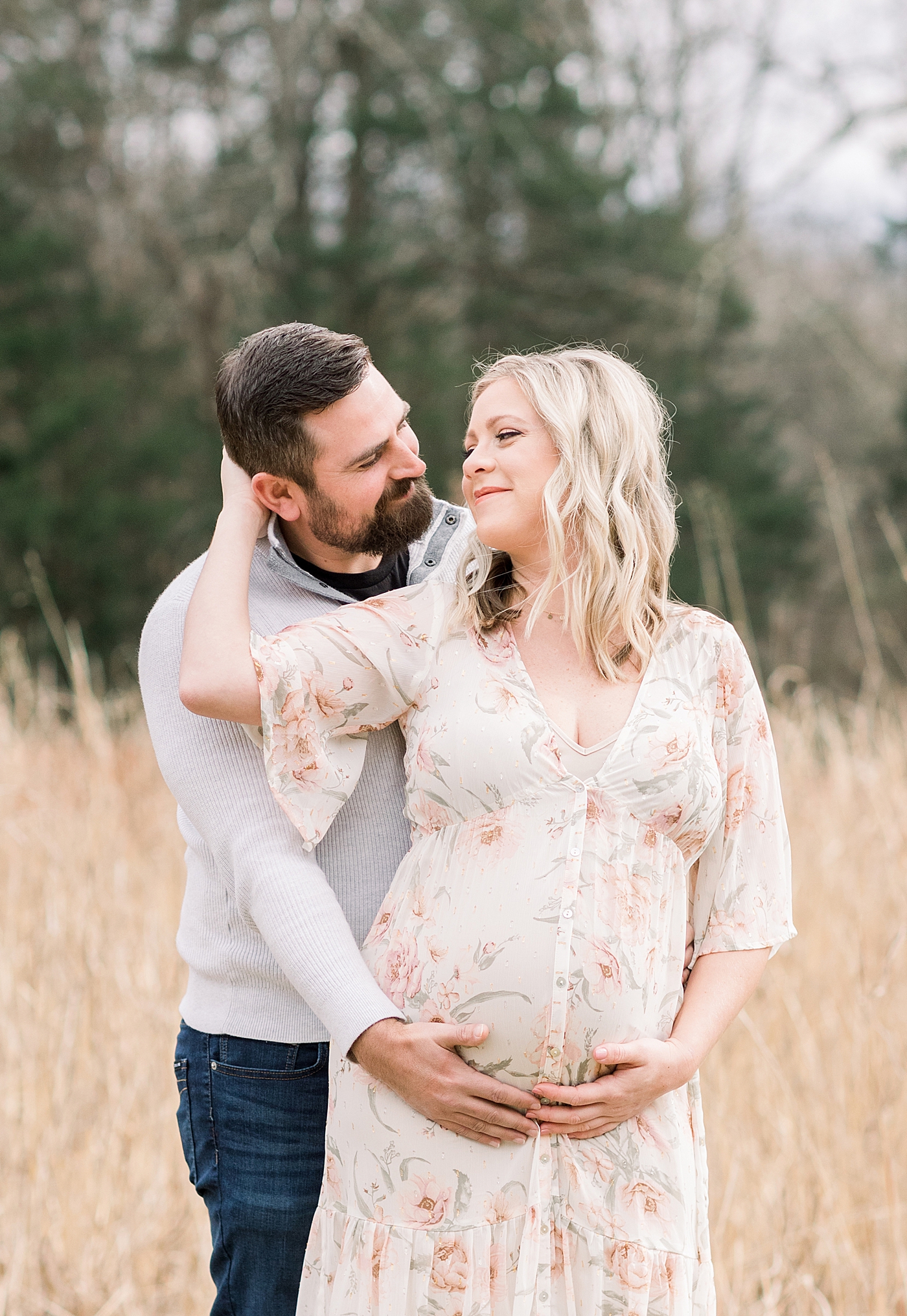 Mom and dad to be in a field | Image by Chrissy Winchester